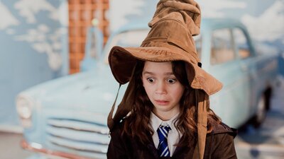 Young girl wearing a sorting hat