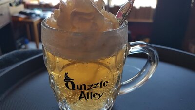Glass of butterscotch flavoured drink called QBrew