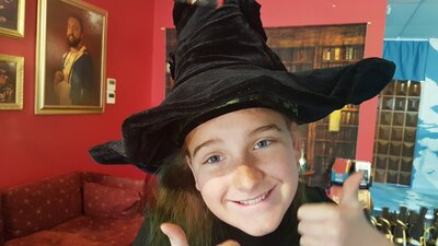 Young girl wearing a witch's hat
