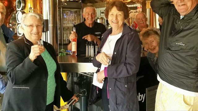 Schnapps anyone? Six seniors in front of schnapps bar