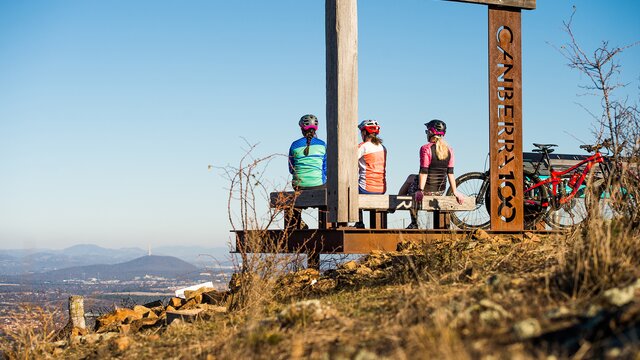 Mountain bike riders admiring the view form One Tree Hill