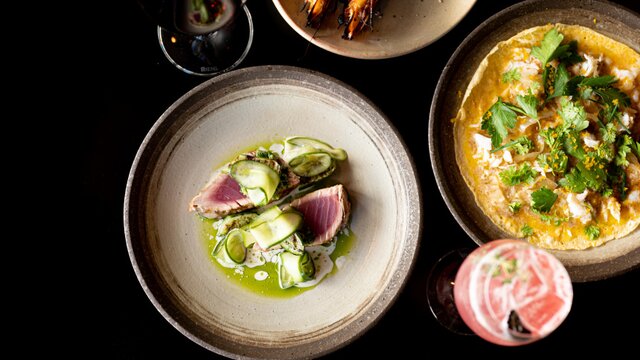 © Ashley St George Aerial of some food dishes on a black table at Temporada | © Ashley St George