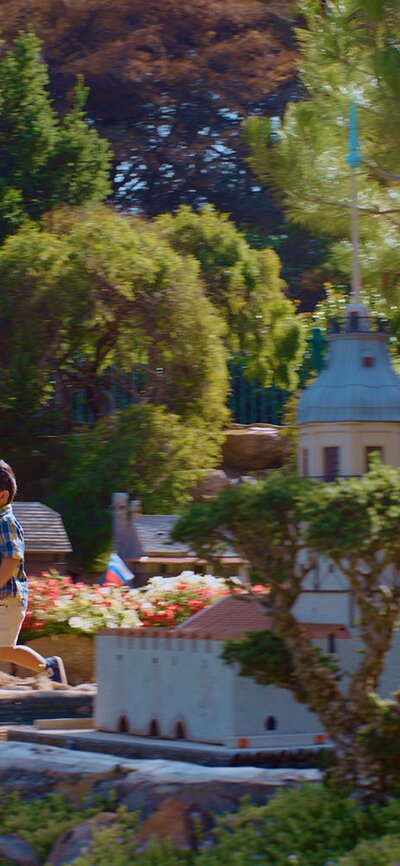 A child playing amongst the miniature sculptures and displays at Cockington Green.