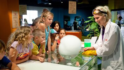 A group of children watching a science experiment at Questacon.