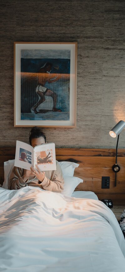 A woman reading in bed.
