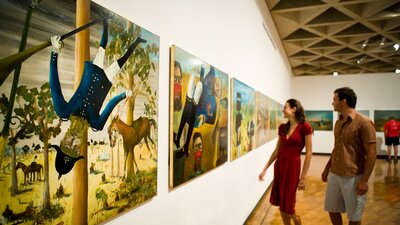 A couple looking at Sidney Nolan's works.