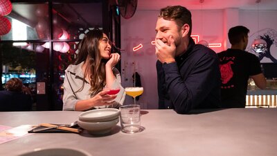 A couple enjoying cocktails at Lazy Su in Braddon.
