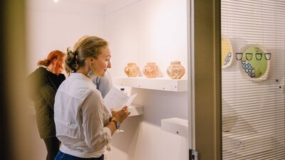 Guests viewing artwork at the Gallery of Small Things.