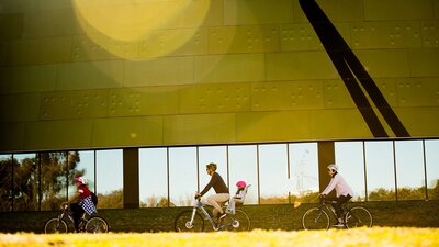 yellow building with a cyclist in front