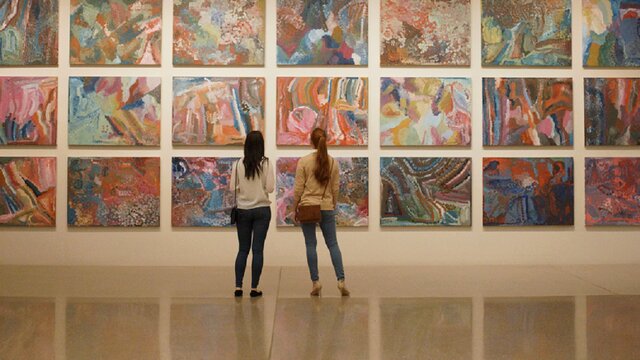 A couple looking at First Nations art at the National Gallery of Australia.