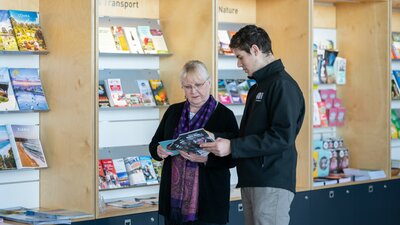 Staff at tourist centre assisting a visitor with information