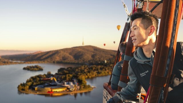A man in a hot air balloon soaring across Canberra national attractions