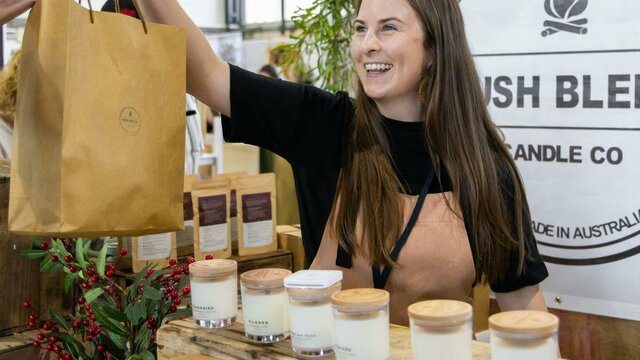 Bush Blend Candle Co Bush Blend Candle Co handing bag to a customer