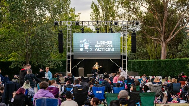 Crowd sitting in front of screen for Lights! Canberra! Action!