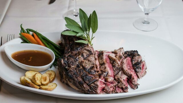 Steak and accompaniments on white plate