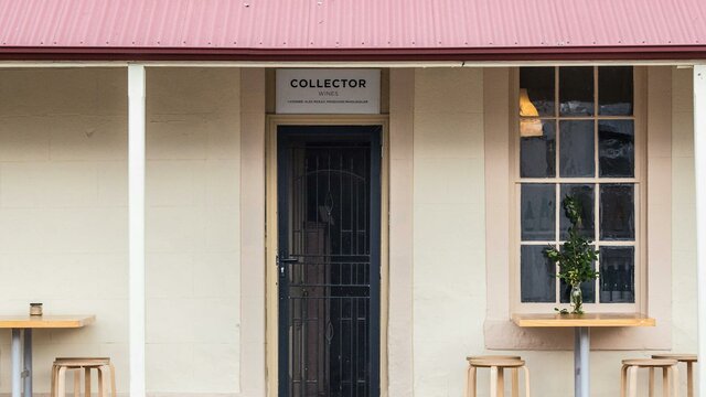 The Collector Wines cellar door is located in the charming country town of Collector. Cafe stools and tables sit outside the entrance to the Collector Wines cellar door.