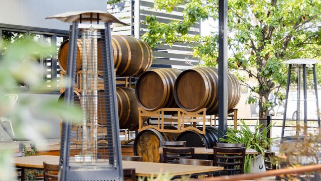 Wine barrels stacked at an urban winery