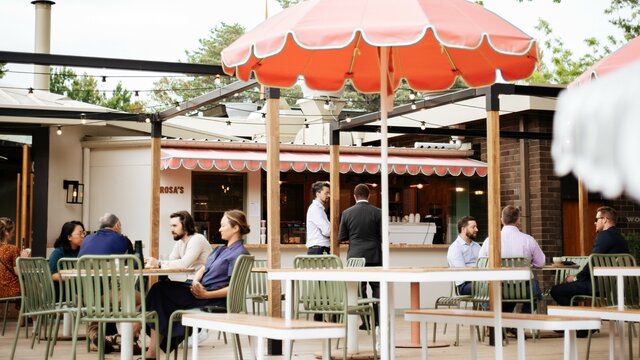 Patrons of an outdoor restaurant sitting down